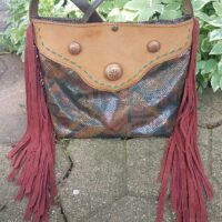 large tote like handbag with snakeskin and fringe