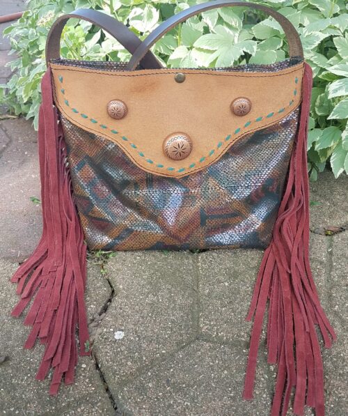 large tote like handbag with snakeskin and fringe